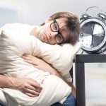 Sad man holding pillow