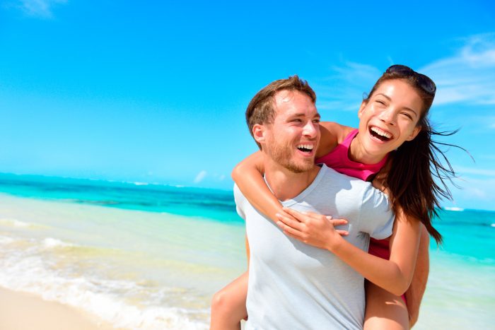 bigstock-Happy-couple-in-love-on-beach--85188443