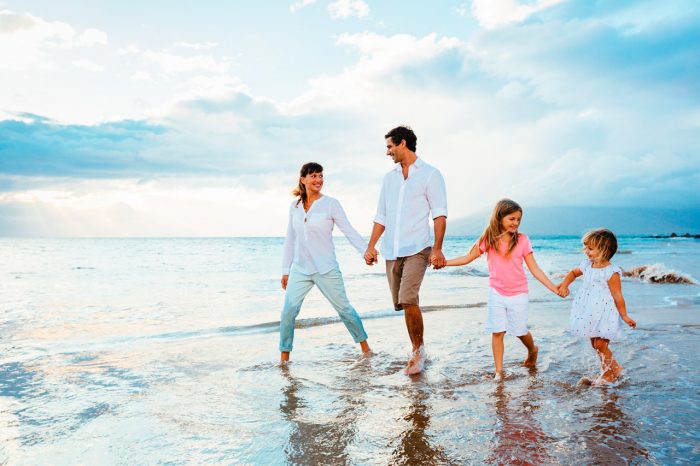 bigstock-Happy-young-family-walking-on--63095971