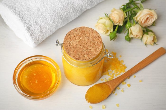 Spa concept. Natural facial mask with honey, towel and flowers o