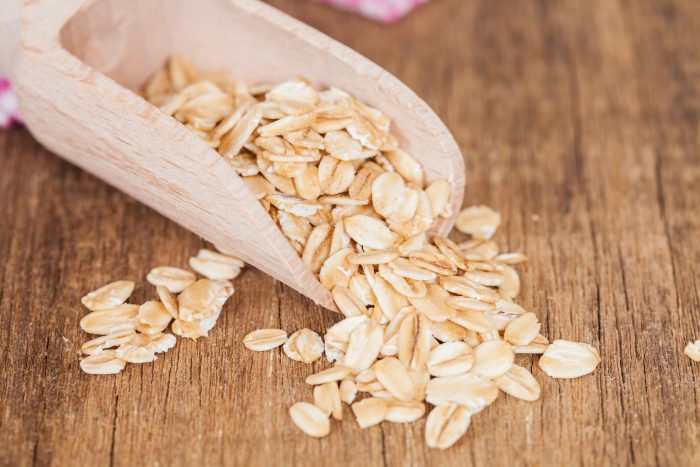 oats flake in spoon on wood table